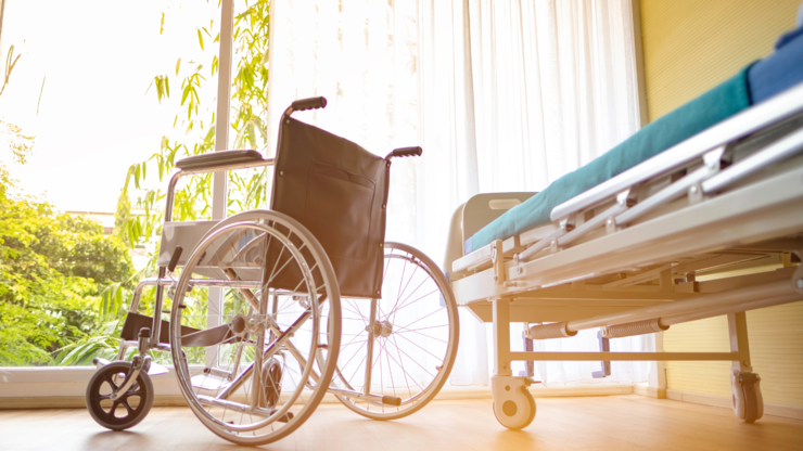 wheel chair and the Patient's bed in the hospital, Empty wheelchair and Patient's bed standing in hospital with sunlight background.