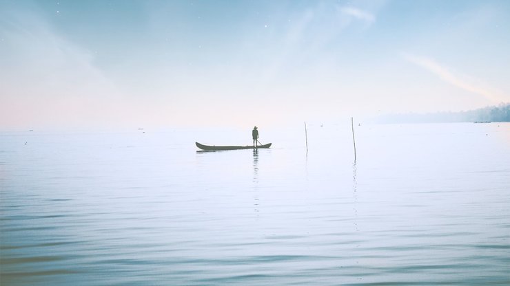  a small boat on a blue ocean