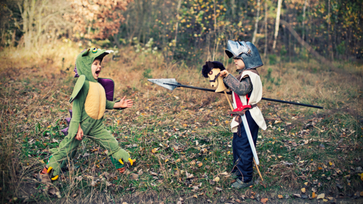 Brave little knight fighting with a roaring green dragon.