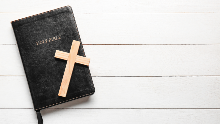 Holy Bible and cross on white wooden background