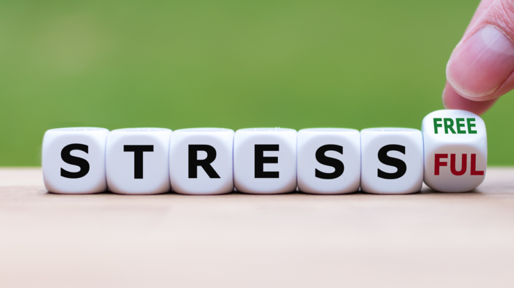Hand turns a cube and changes the expression "stressful" to "stress free".