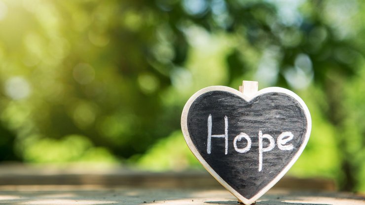Hope - inscription on the heart, sharing hope concept, green bokeh background