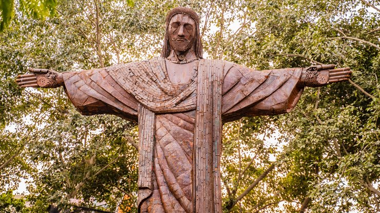 Brown Wooden Statue Under Green Tree